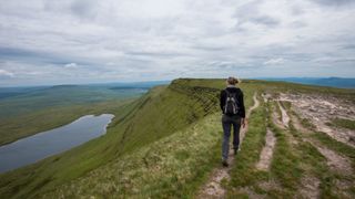 Woman walking along the top of a hill