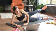 Woman doing floor-based exercise with resistance band